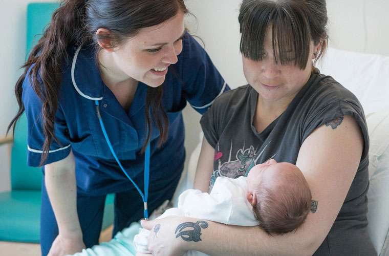 Maternity Nurse with young mother and baby