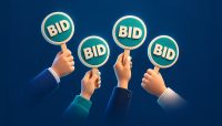 hands holding up bidding signs on a blue background